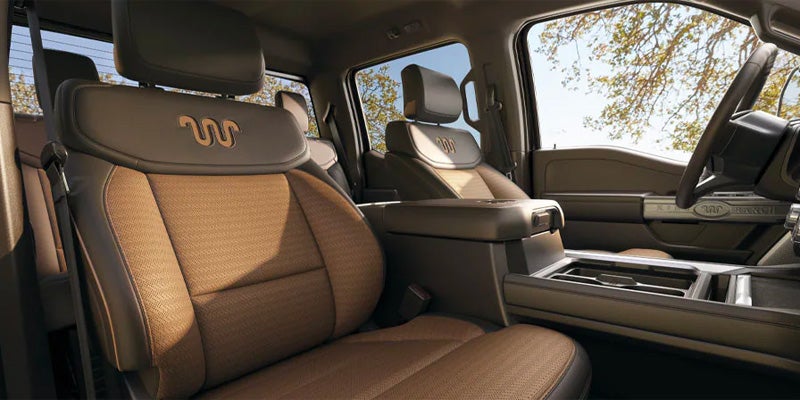 Interior of a truck cab, showing the King Ranch branded leather seats and center console